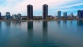 Kayakers North American lake, business towers background. Business juxtaposed leisure, kayakers against city towers