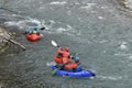 Kayakers on whitewater in Rhine Gorge Ruinaulta in Switzerland in back view.