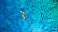 Kayaking. Aerial view of floating kayaks and people on blue sea at sunny day. Travel and active life image. Royalty Free Stock Photo