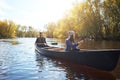 Kayaking it as a couple. a young couple going for a canoe ride on the lake.