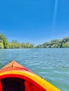 Kayaking Adventure: Exploring the Serene River Amidst Verdant Trees on a Sunny Day