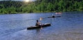 Kayaking On A Beautiful Lake with Sun over Trees Royalty Free Stock Photo