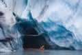 Kayaking into blue ice cave Royalty Free Stock Photo