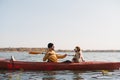 Kayaking with dogs: man rowing a boat on the lake with his spaniel. Royalty Free Stock Photo