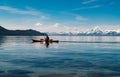 Kayaking on Lake Tahoe with snow capped mountains in spring time