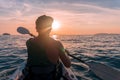 Kayaking. Man With kayak paddle at sunset sea Rowing to the Sun. Royalty Free Stock Photo