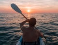 Kayaking. Man With kayak paddle at sunset sea Rowing to the Sun. Royalty Free Stock Photo