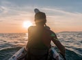 Kayaking. Man With kayak paddle at sunset sea Rowing to the Sun. Royalty Free Stock Photo