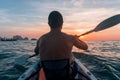 Kayaking. Man With kayak paddle at sunset sea Rowing to the Sun. Royalty Free Stock Photo