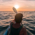 Kayaking. Man With kayak paddle at sunset sea Rowing to the Sun. Royalty Free Stock Photo