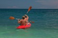 Kayaking in the sea from back view