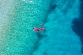 Kayaking. Sup. Aerial view of floating board and people on blue sea at sunny day. Travel and active life image. Royalty Free Stock Photo