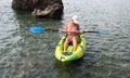 Woman kayak sea. Happy tourist enjoy taking picture outdoors for memories. Woman traveler posing in kayak canoe at sea Royalty Free Stock Photo
