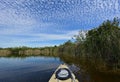 Kayaking under beautiful summer cloudscape reflected on Nine Mile Pond in Everglades National Park, Florida.