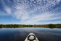 Kayaking under beautiful summer cloudscape reflected on Nine Mile Pond in Everglades National Park, Florida.