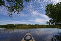 Kayaking under beautiful summer cloudscape reflected on Nine Mile Pond in Everglades National Park, Florida.