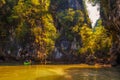 Kayaking under high cliffs in Thailand