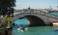 Kayaking under one of many bridge in venice iataly