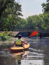 Kayaking A young man is canoeing down the river. Rear view. Sports tourism and active leisure in beautiful nature Royalty Free Stock Photo