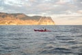 Kayaks. Canoeing in the sea near the island with mountains. People kayaking in the ocean. Royalty Free Stock Photo