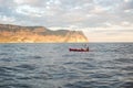 Kayaks. Canoeing in the sea near the island with mountains. People kayaking in the ocean Royalty Free Stock Photo