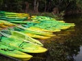 Kayaks and canoes on the river bank. Royalty Free Stock Photo