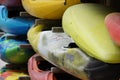 Kayaks and canoes are stored and piled in racks in detail in side view. They wait for start of water sport season. Royalty Free Stock Photo