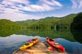 Kayaks docked on mountain lake Royalty Free Stock Photo