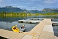 Kayaks floating on a mountain lake at a dock during the day Royalty Free Stock Photo