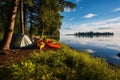 kayaks on a lake shore near a camping site Royalty Free Stock Photo