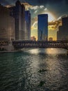 Kayaks provide recreational activities to tourists as the Chicago River reflections of sunset and buildings as sun sets