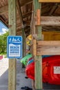 Kayaks for rent on wooden rack at marina with beach access sign - West Lake Park, Hollywood, Florida, USA