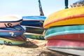 Kayaks on sand beach. Colorful boats in front of sea coast. Royalty Free Stock Photo