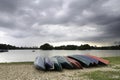 Kayaks on the shore of the lake with dramatic clouds Royalty Free Stock Photo