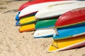 Kayaks stacked on sand beach. Royalty Free Stock Photo