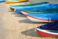 Kayaks stacked on sand beach. Colorful boats in front of sea coast. Royalty Free Stock Photo