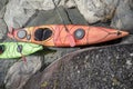 Kayaks stand moored on a rocky seashore. Top view. Royalty Free Stock Photo