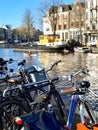 Kayaks on Amstel river in central Amsterdam and parked bicycles by the canal side Royalty Free Stock Photo