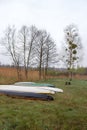 Kayaks of water tourists during a halt in the camp. Dry reed and swampy terrain of Volyn in May. Spring in Europe