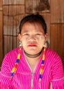 Kayan girl in bright traditional national clothes in Padaung Tribe Village of Long Neck People