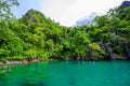 Kayangan Lake - Blue crystal water in paradise lagoon - walkway on wooden pier in tropical scenery - Coron island, Palawan, Royalty Free Stock Photo