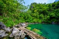 Kayangan Lake - Blue crystal water in paradise lagoon - walkway on wooden pier in tropical scenery - Coron island, Palawan, Royalty Free Stock Photo