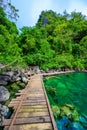 Kayangan Lake - Blue crystal water in paradise lagoon - walkway on wooden pier in tropical scenery - Coron island, Palawan, Royalty Free Stock Photo