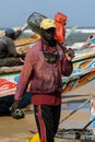 Unidentified Senegalese man holds a fishing net on the coast of Royalty Free Stock Photo