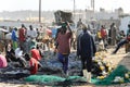 Unidentified Senegalese people make fishing nets on the coast o