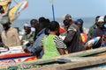 Unidentified Senegalese people sit on the boats on the coast of