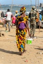 Unidentified Senegalese woman carries her baby behind her back