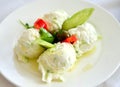 kaymak with vegetables and olive oil on white plate Royalty Free Stock Photo