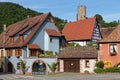 Traditional Alsacian architecture with old castle tower in Kaysersberg Royalty Free Stock Photo