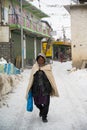 KAZA, SPTI, INDIA - Dec 14, 2019: An Old Lady walking in the middle of a Snow Royalty Free Stock Photo